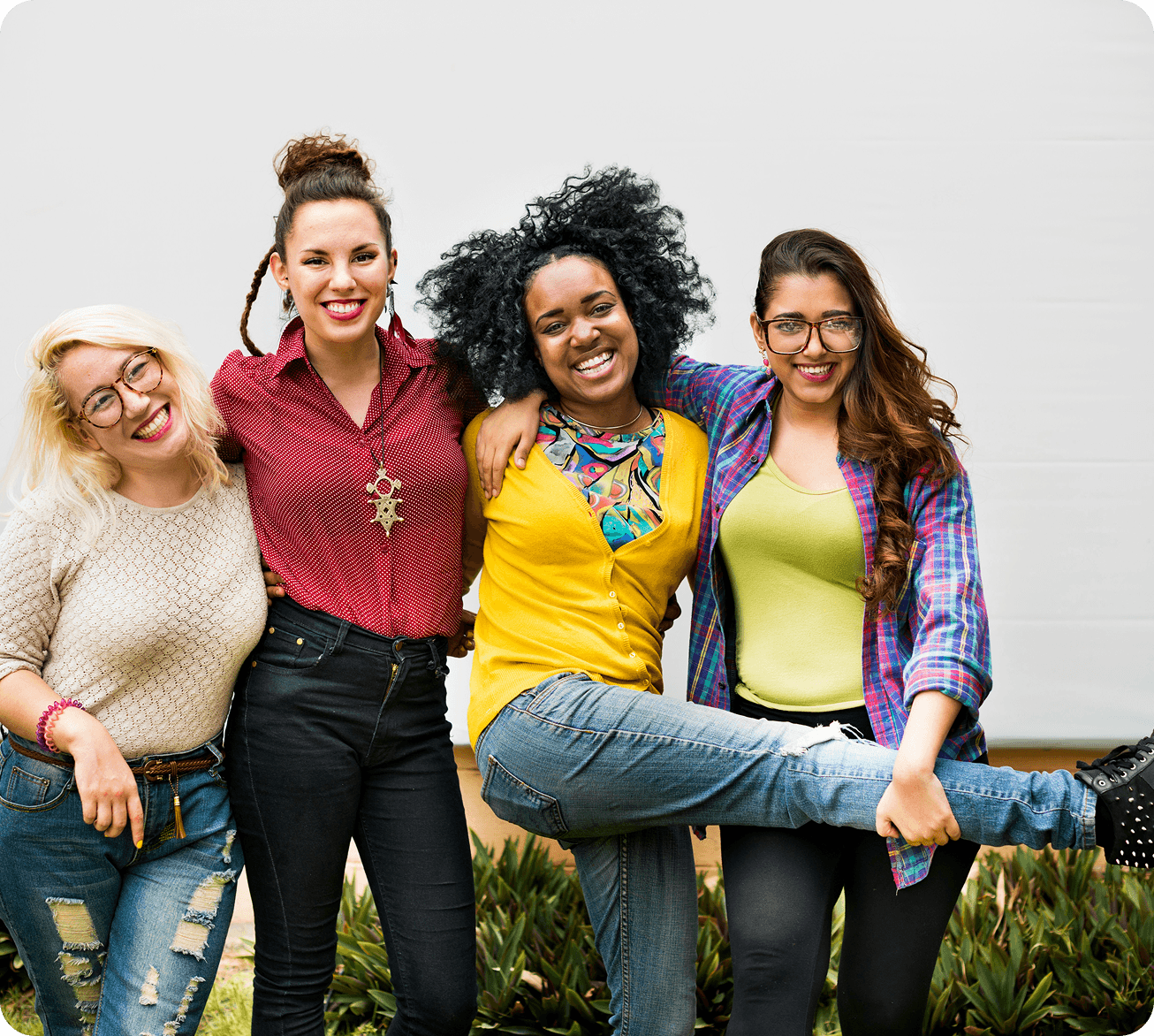 Four women arm-in-arm, holding each other up.