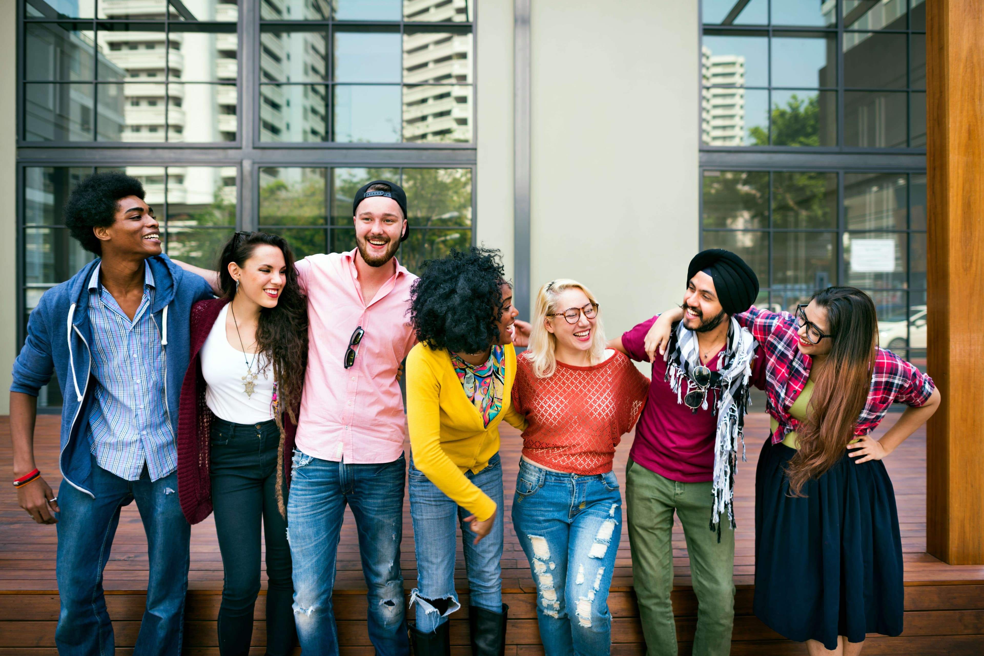 A group of friends standing arm-in-arm